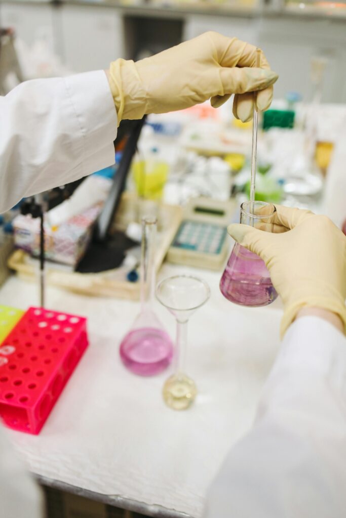 Scientist pouring chemicals for research experiment in a lab setting.